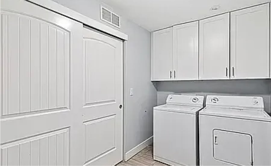 The Laundry Room is conveniently located upstairs with washer, dryer, and laundry basket.