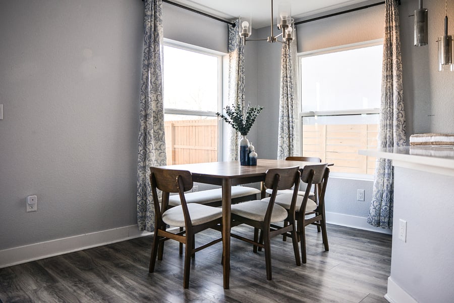 Bright and relaxing dining area seating six with views toward the backyard. Seating includes 4 chairs, bench (and high chair if needed).
