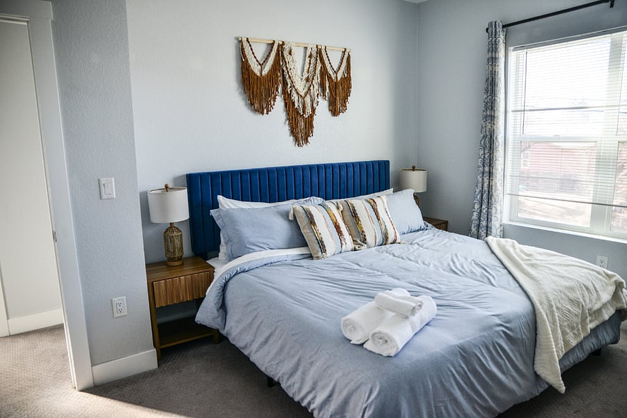 Enjoy mountain views from the Guest King bedroom with sitting area, closet, dresser, 40" smart tv. Walk a few steps to full bathroom with bathtub.