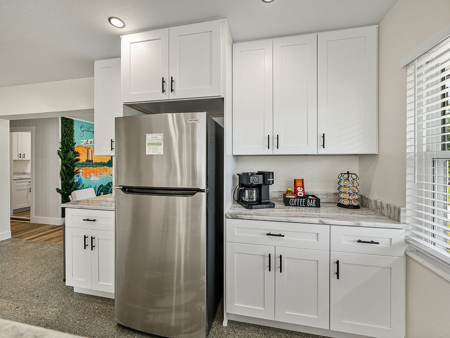 This stylish coffee bar features a dual Keurig system for drip coffee and single-serve cups, offering both hot and cold beverage options. Sleek storage keeps Keurig cups, creamers, and sweeteners organized, blending style and functionality.