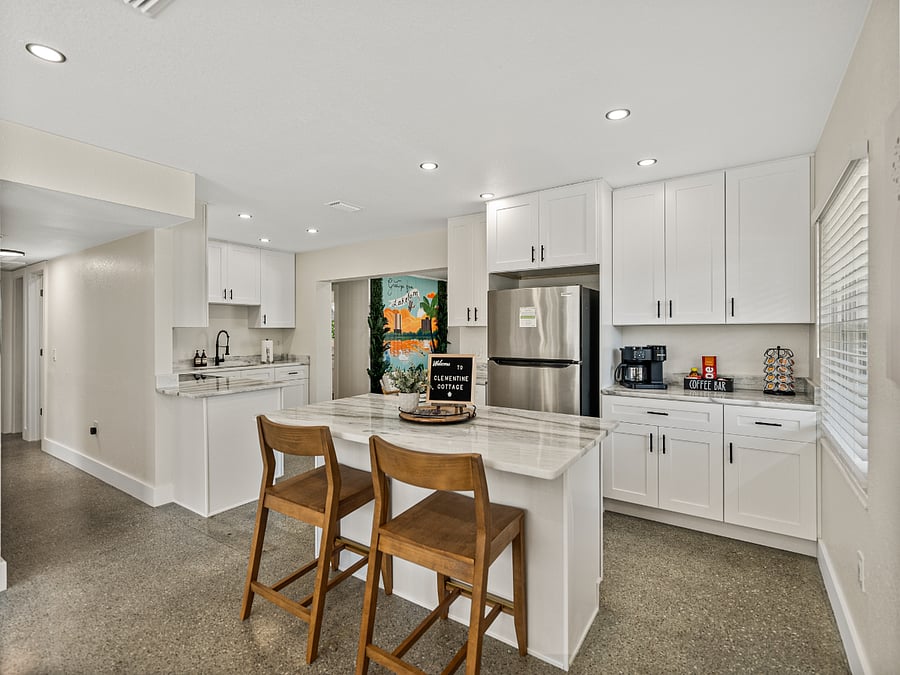 Enjoy meals, morning coffee, or casual chats at the spacious eat-in counter, perfectly set in a bright, open-concept kitchen. With natural light, clean finishes, and comfy seating, it flows seamlessly into the living area.
