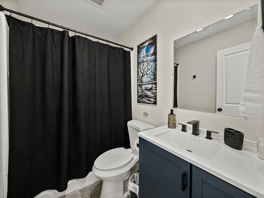 The spacious, clean bathroom includes a shower/tub combo for relaxing soaks. Enjoy fresh towels, shampoo, conditioner, body wash, and a hairdryereverything you need for a comfortable stay.