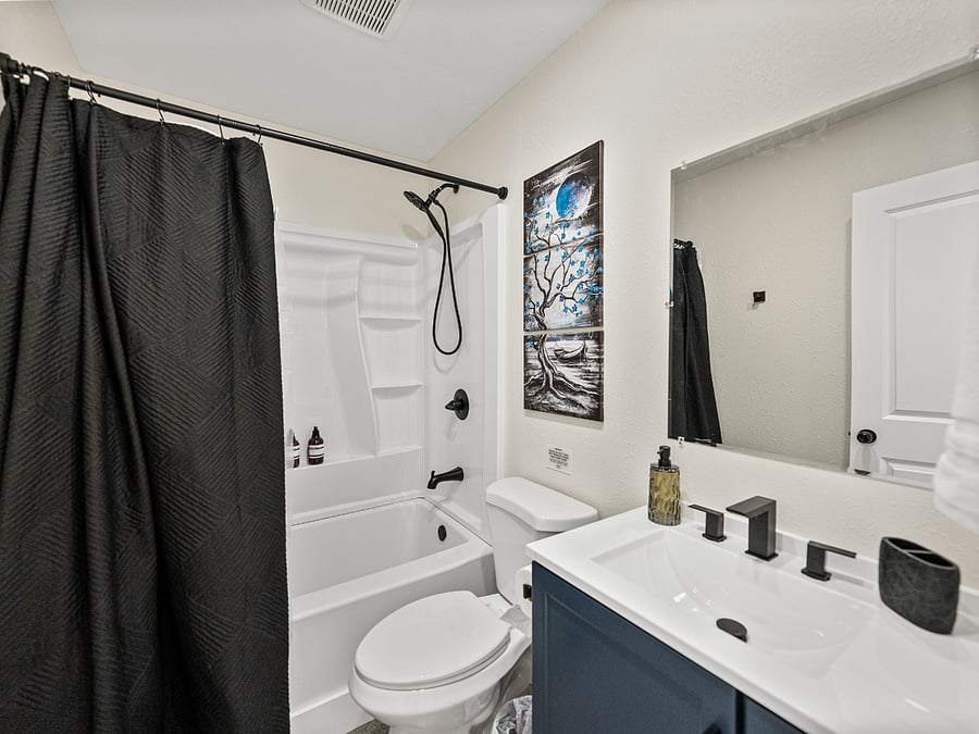 The spacious, clean bathroom includes a shower/tub combo for relaxing soaks. Enjoy fresh towels, shampoo, conditioner, body wash, and a hairdryereverything you need for a comfortable stay.