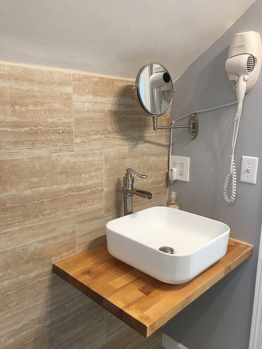 Sink, hair dryer and full body mirror.
