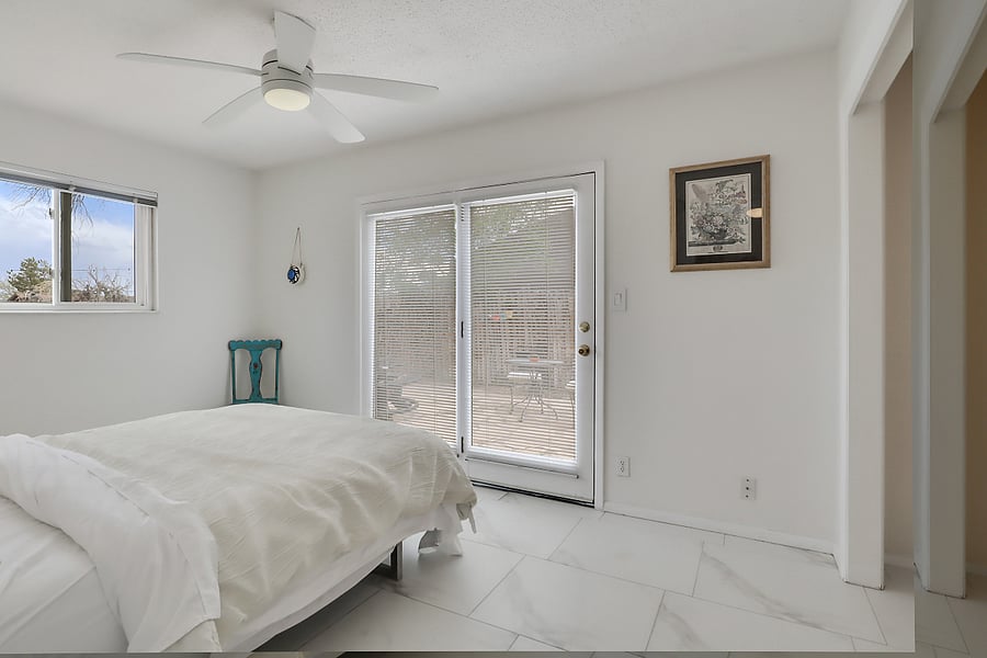 Bedroom #1 with french door leading to private patio