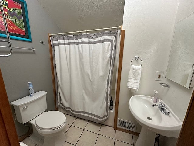 Full bathroom with several shelves to the right.