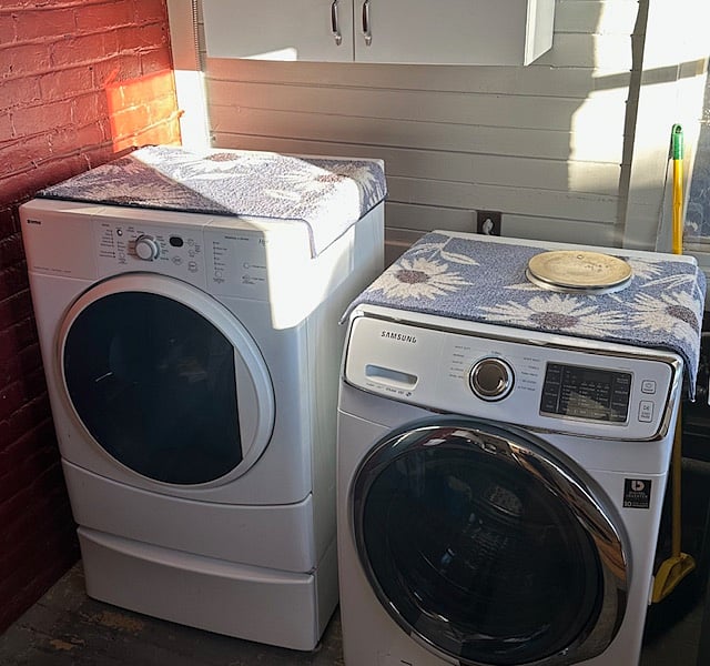 Shared washer and dryer at bottom of stairs to the studio.
