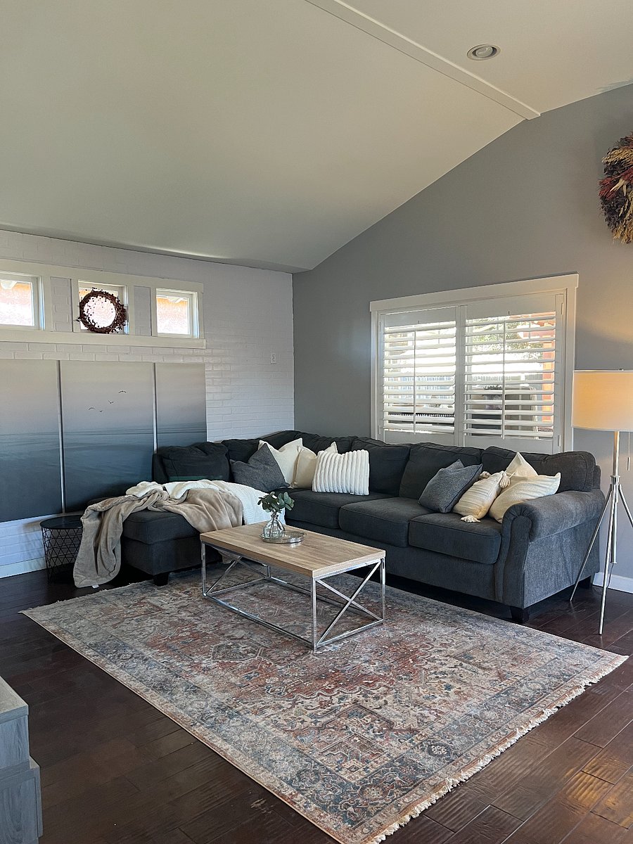 large living space with sectional and high ceilings