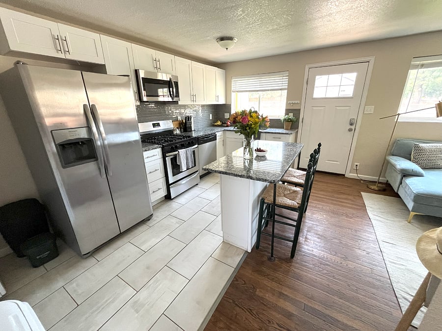 Updated kitchen with island, ice maker, water dispenser, dishwasher.