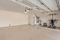 Two car garage and workout equipment.