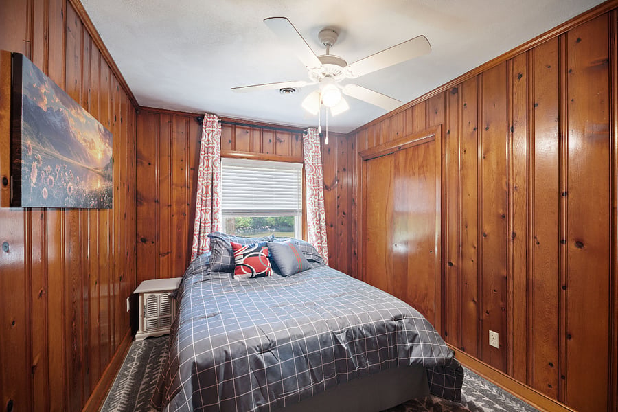 Back bedroom with dresser and TV