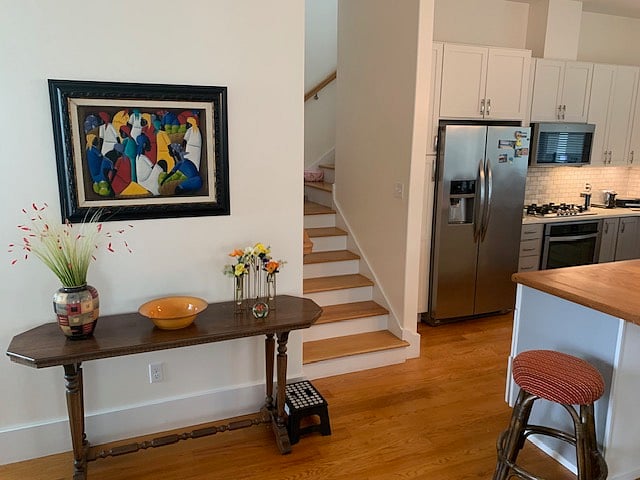 stairway to second level off kitchen / dining room / living room