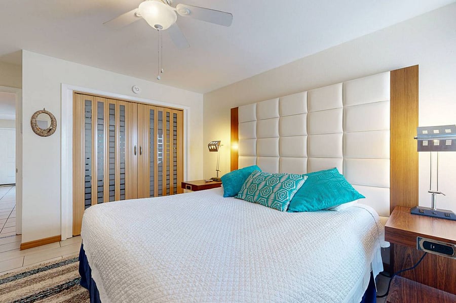 Main bedroom features statement headboard and ample closet space