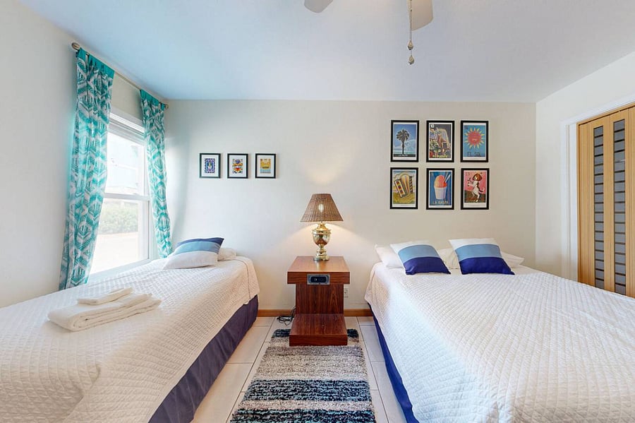 Second bedroom features local art and two beds