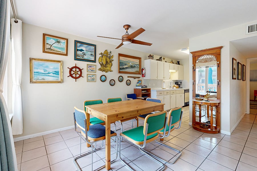 Dining room with theme gallery wall -- table extender available to spread out or host guests