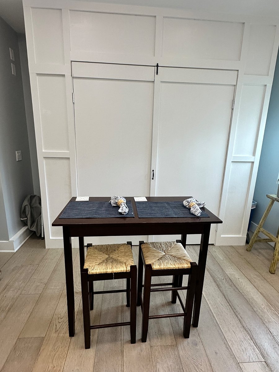 View of pull down Queen murphy bed and bar-top table.