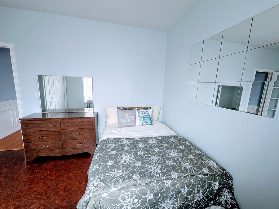 Full size bed, 2 standard size pillows, 1 king size pillow, 2 sets of sheets, bed spread, comforter, and duvet cover.