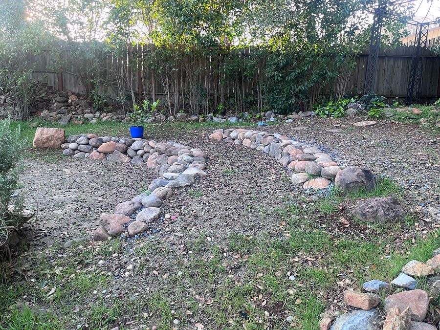 The shared backyard. We will be building raised beds on these terraces this spring.