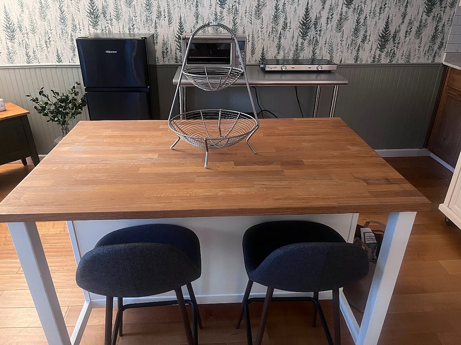 This is the kitchen island, great for preparing meals, working, and eating. There is also storage under the kitchen island.
