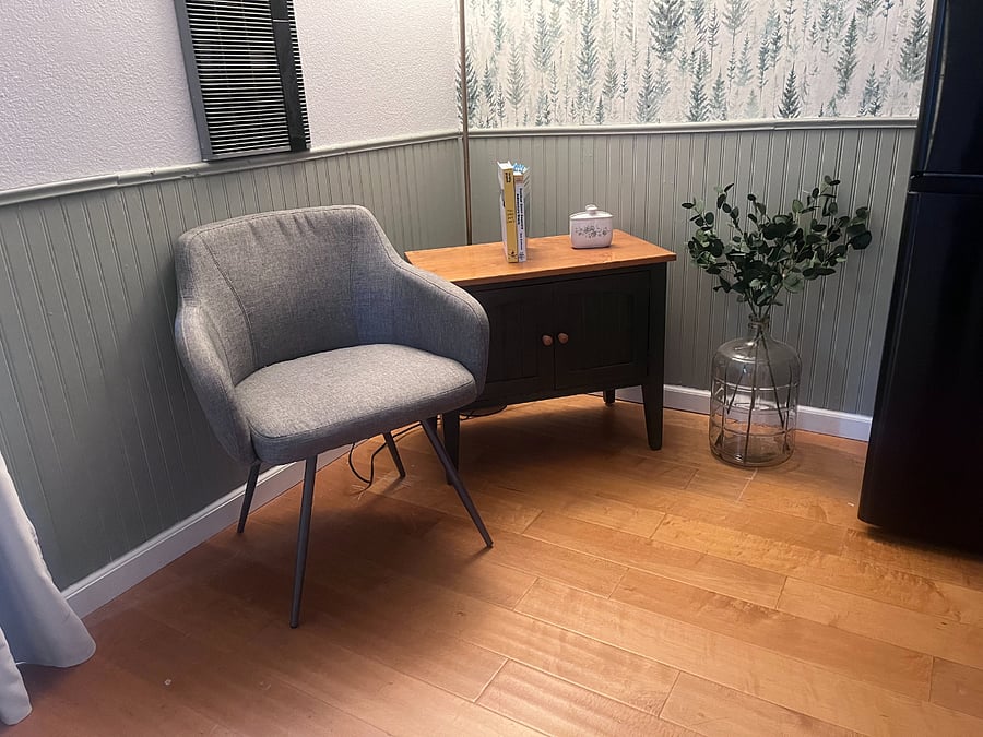 Accent chair with books, games, and home/neighborhood information.