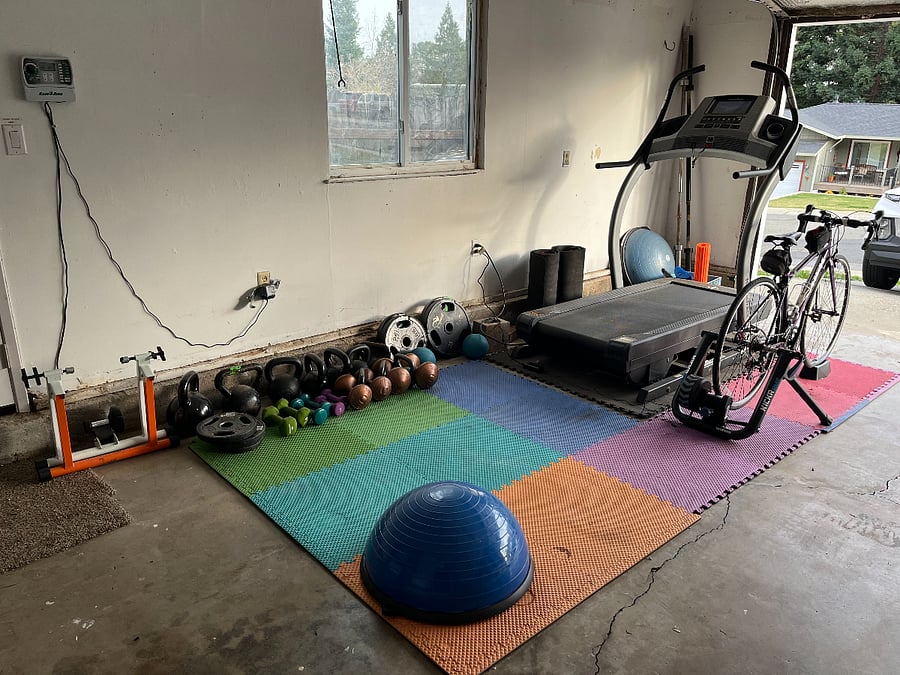 Shared garage gym equipment. Treadmill, weights, bike trainer, yoga mats.