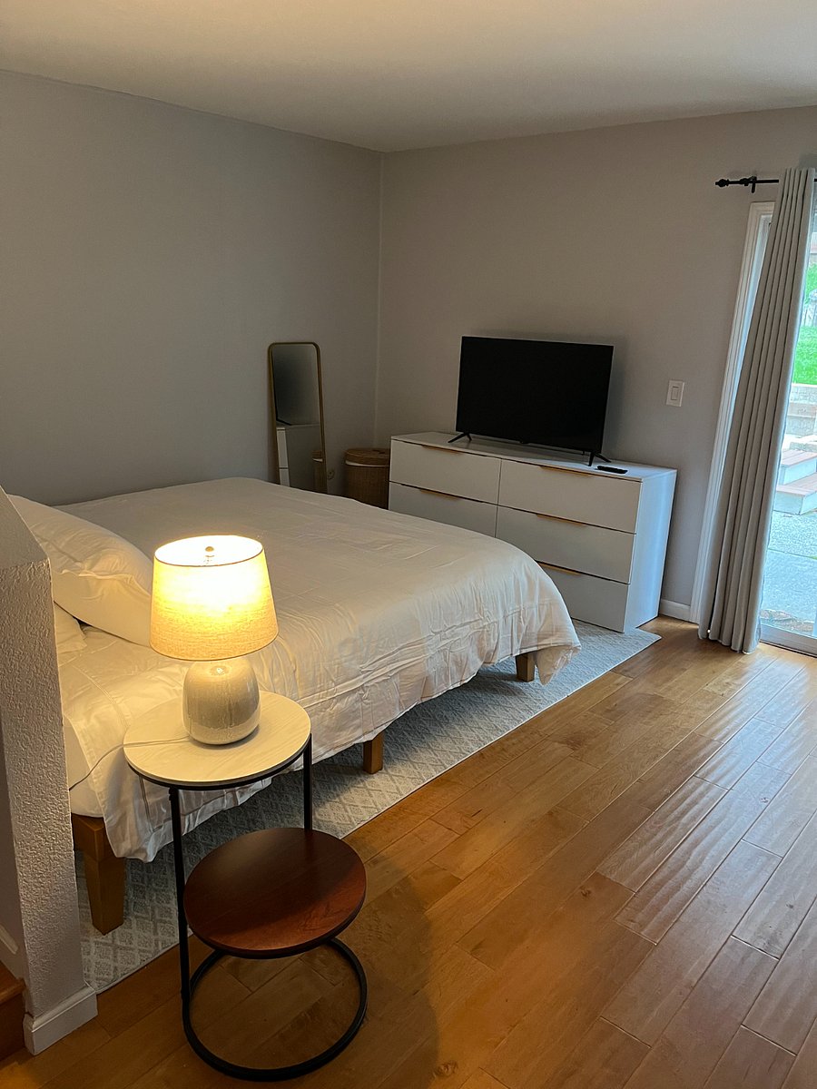 King bed, side table, hamper, and full-length mirror. Flatscreen smart TV comes with Amazon Fire Stick