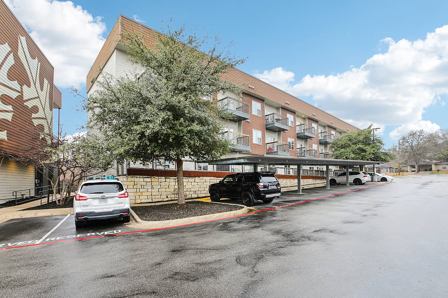 Exterior of condo community with lots of guest parking