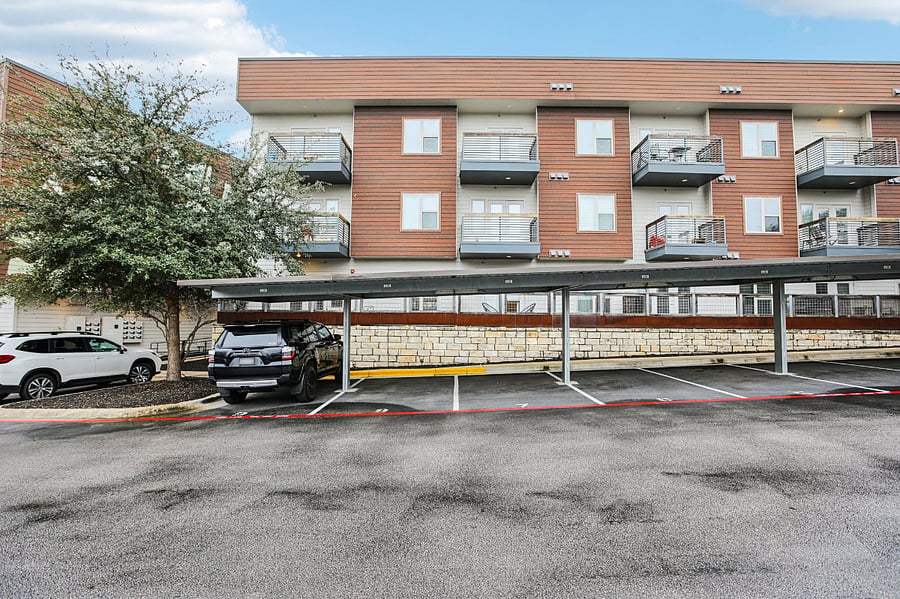Exterior of condo community with lots of guest parking