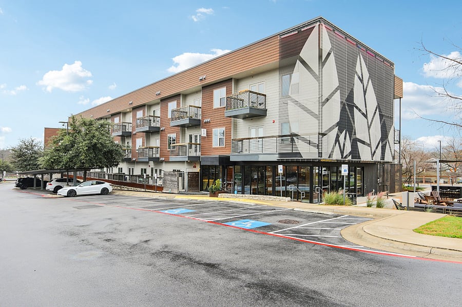 Exterior of condo community with lots of guest parking