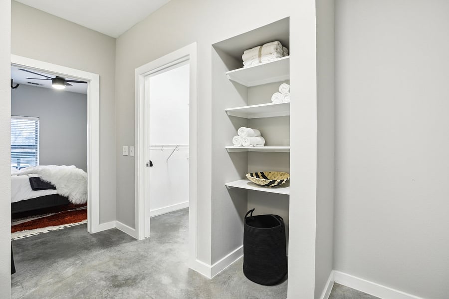 Large closet and built-in shelves inside the bathroom