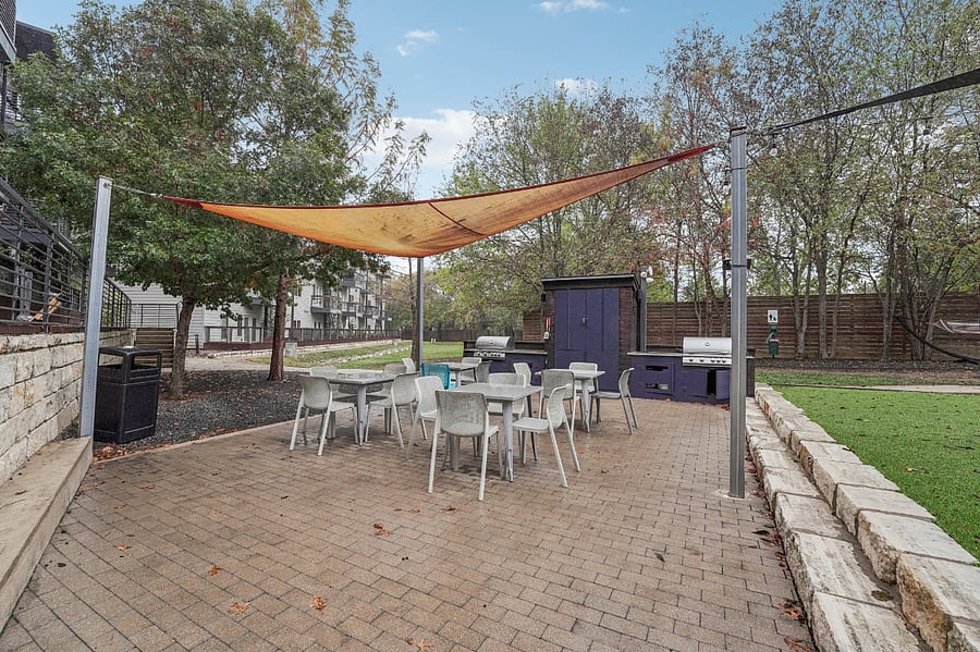 Outdoor community lounge area with grills and grilling utensils