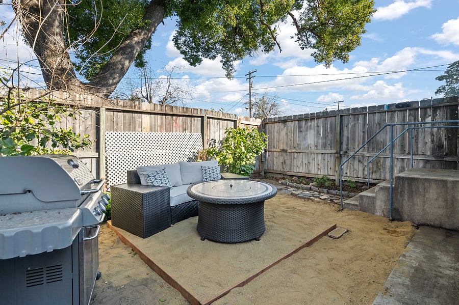 Backyard is private and relaxing with shade tree, lounge area, fire pit, and Weber BBQ Grill.