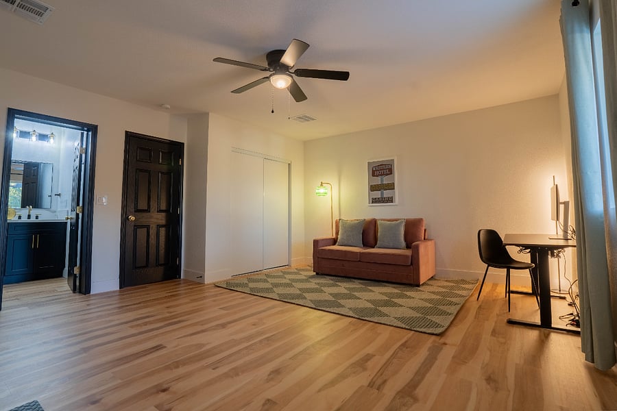 Den - Sofa bed with working standing desk with monitor and gym area