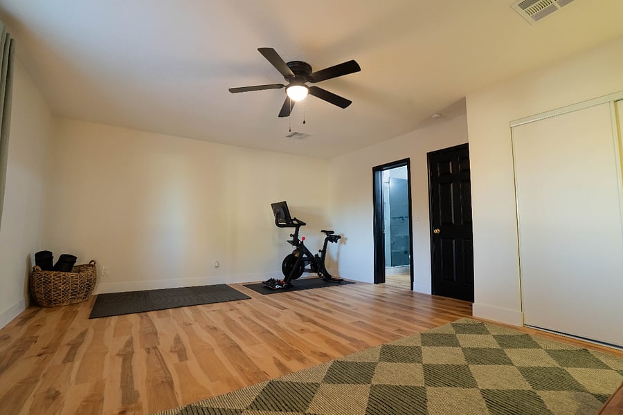 Den - Sofa bed with working standing desk with monitor and gym area