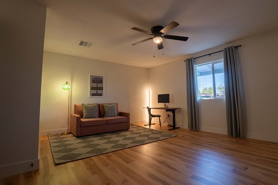 Den - Sofa bed with working standing desk with monitor and gym area