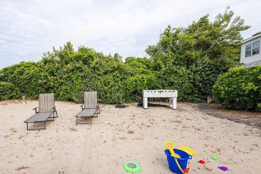 Backyard area to relax and get some sun. Beach chairs and foosball table amenities.