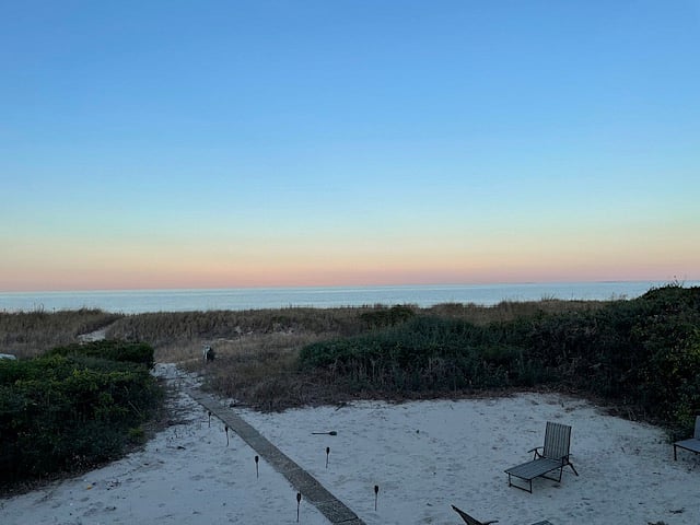 Backyard view from deck. This photo was taken as the sun was going down. Enjoy the water views from the backyard deck.