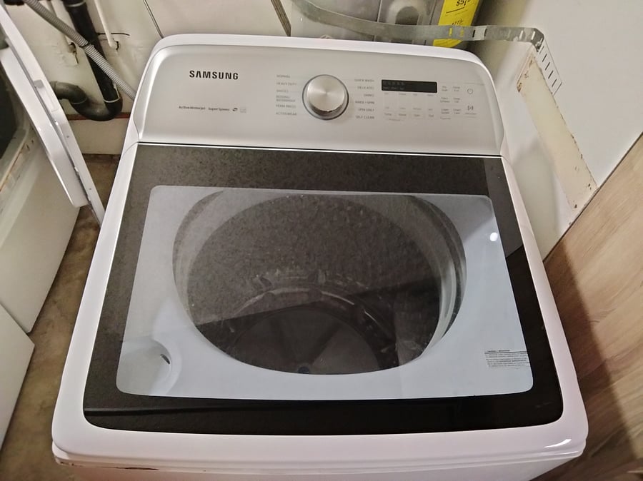 Large capacity washing machine is in the garage.