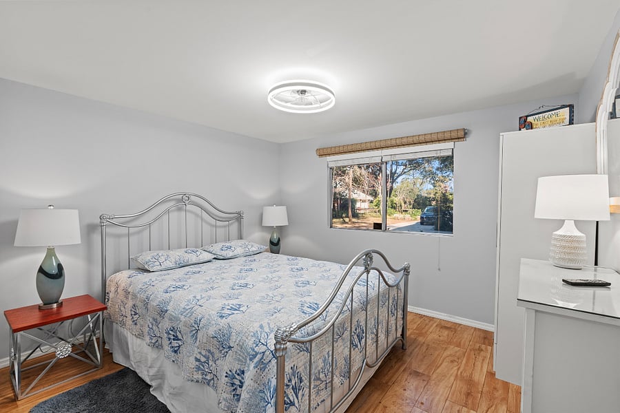 Primary bedroom with queen-size bed and plenty of clothes storage
