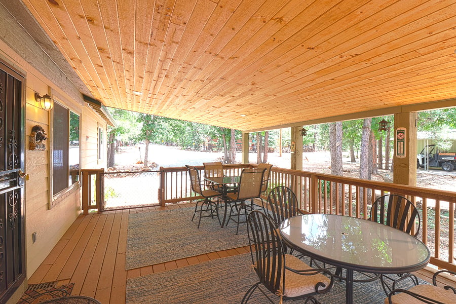Another view of the large covered porch. All three gates on the porch can be secured so you can let your dog play out there.
