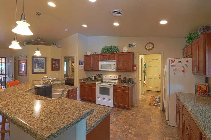 Kitchen with all the usual appliances including coffee maker and toaster. Plenty of pots and pans, dishes, glassware, tableware, and utensils. It's well-stocked.