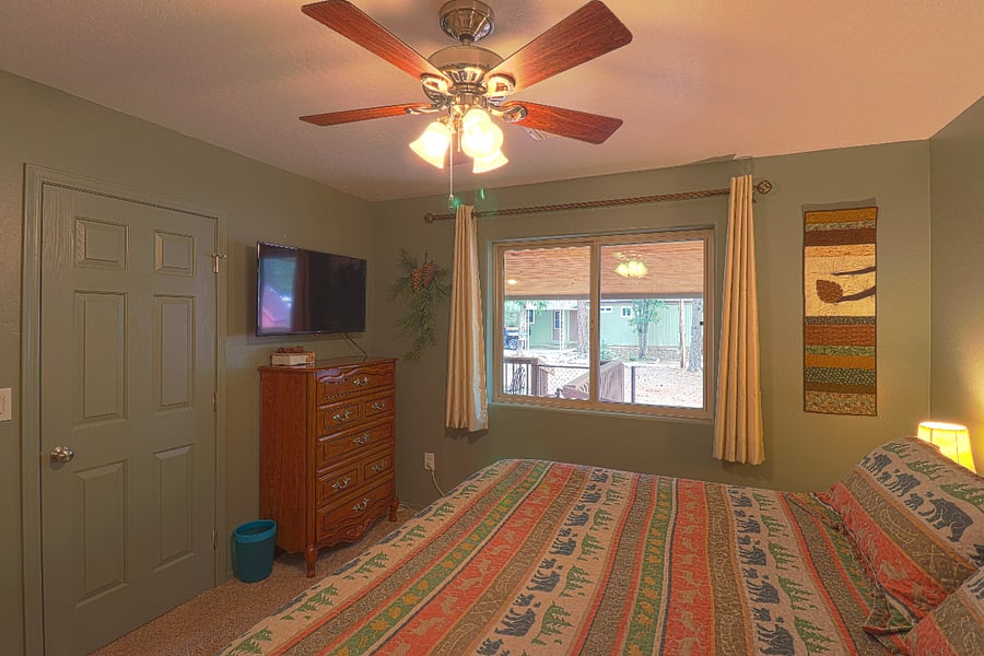 The main bedroom has a large smart TV, and a nice view outside as well.
