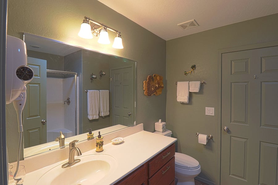 The main bathroom has a walk-in shower with a bench seat inside.