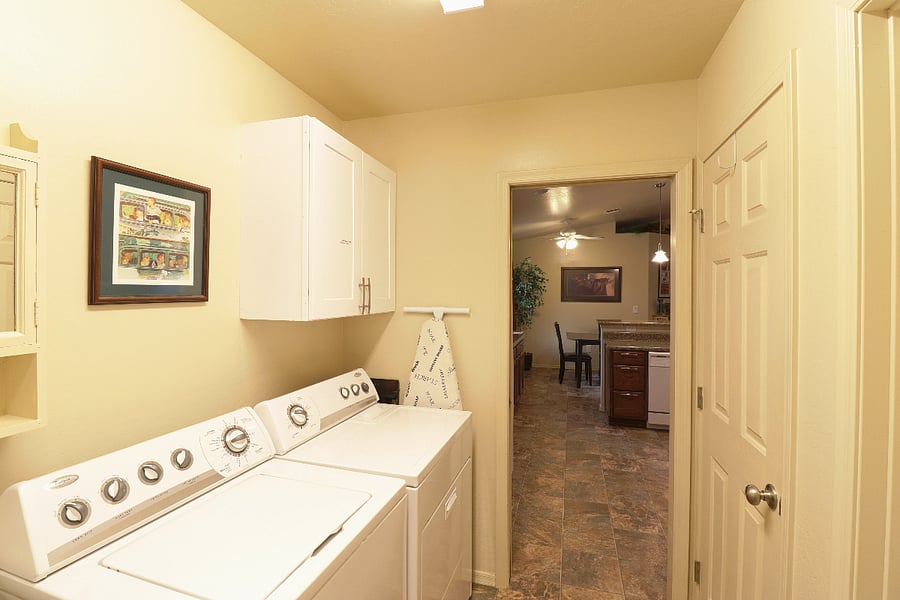 The laundry area is next to the kitchen. The door on the right is the pantry.
There is also a large laundry sink which some guests have used to wash their dog.