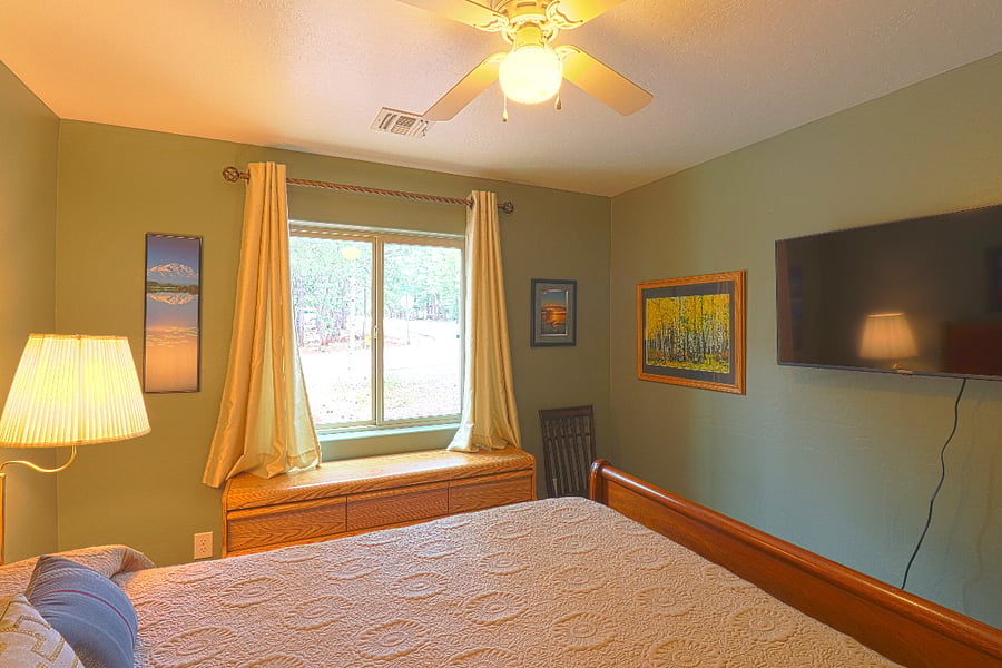 The second bedroom has a large smart TV.
