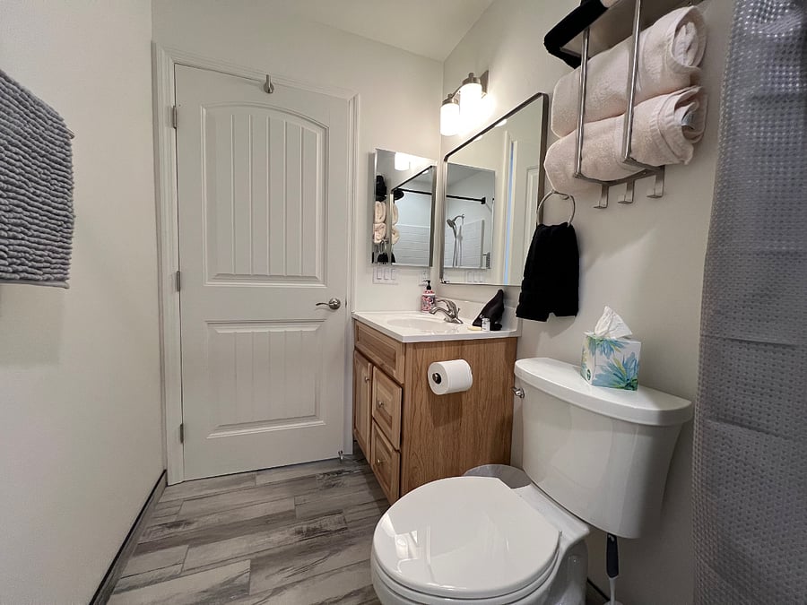 A spacious vanity shines with drawers for your personal items, stylish sink, and oversized mirror, ideal for your daily glow-up, with smart under-sink storage to keep essentials organized.

