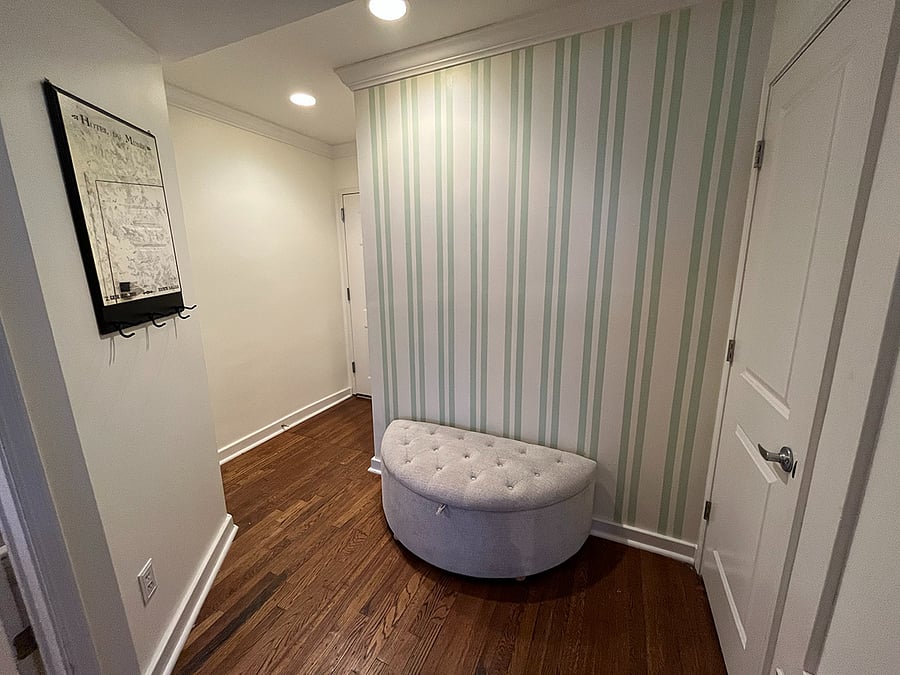 View of entryway with storage ottoman.