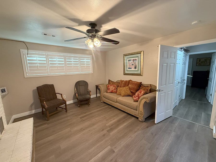 Family Room with Shutters & Fireplace w/ Bedroom 1 through Hallway
