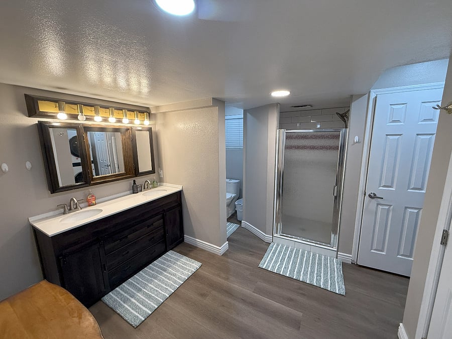 Bathroom w/ 2-Sinks, Toilet, Walk-In Shower. Washer & Dryer around corner is not visible