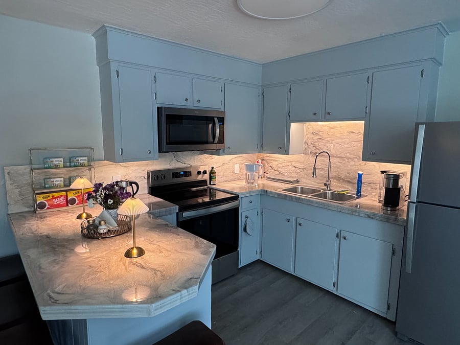 Full stocked kitchen with calming cabinet accent lighting.